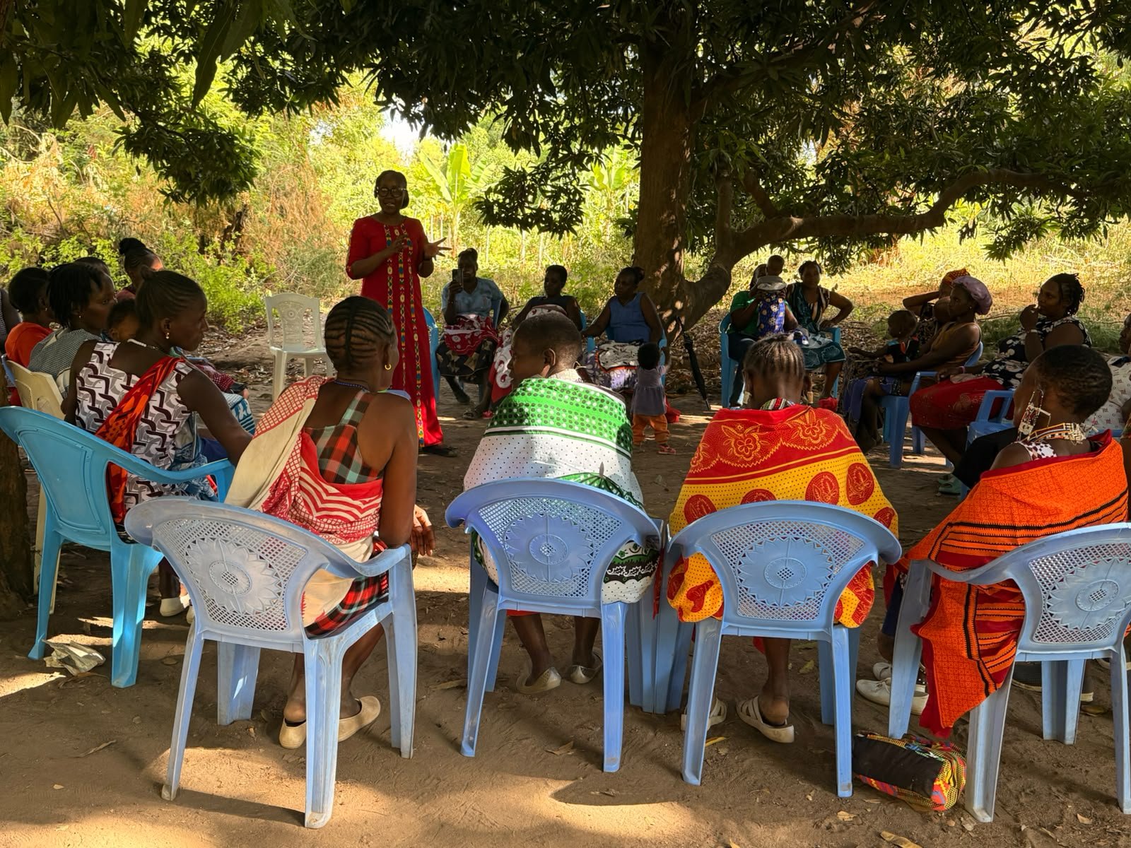 Women discussing goat and chicken rearing opportunities